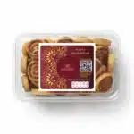 Delicious Indian sweet snack Poona Bhakarwadi in a clear plastic container, perfect for gifting or sharing.
