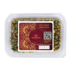 Fresh spicy fried green peas in clear plastic container, ideal for snacks and healthy eating.